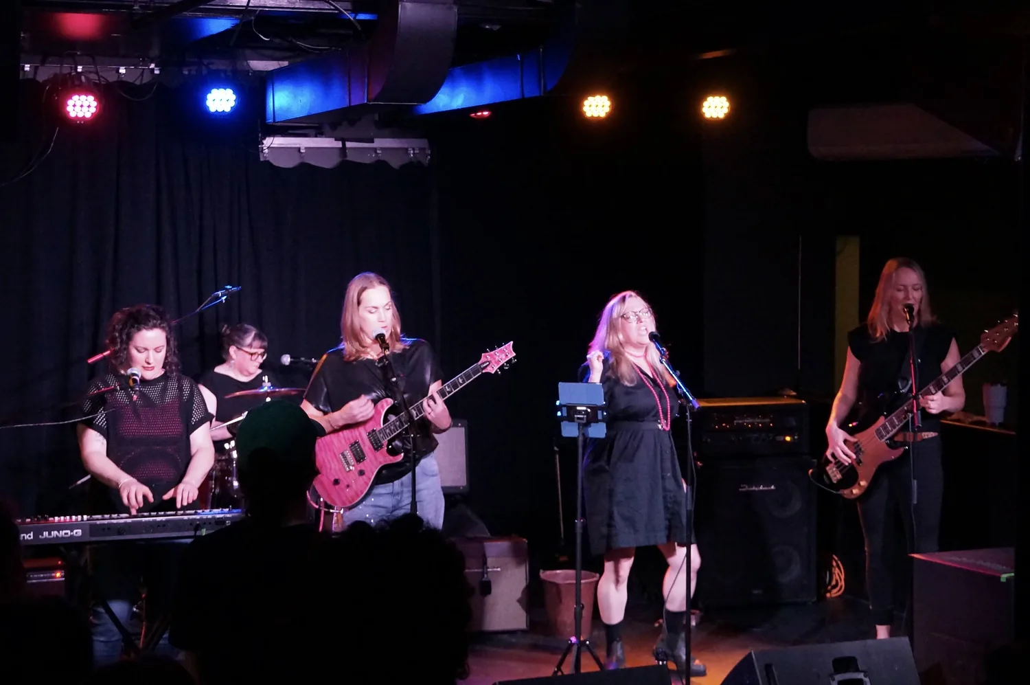The full band on stage — keys, drums, guitars, bass and vocals